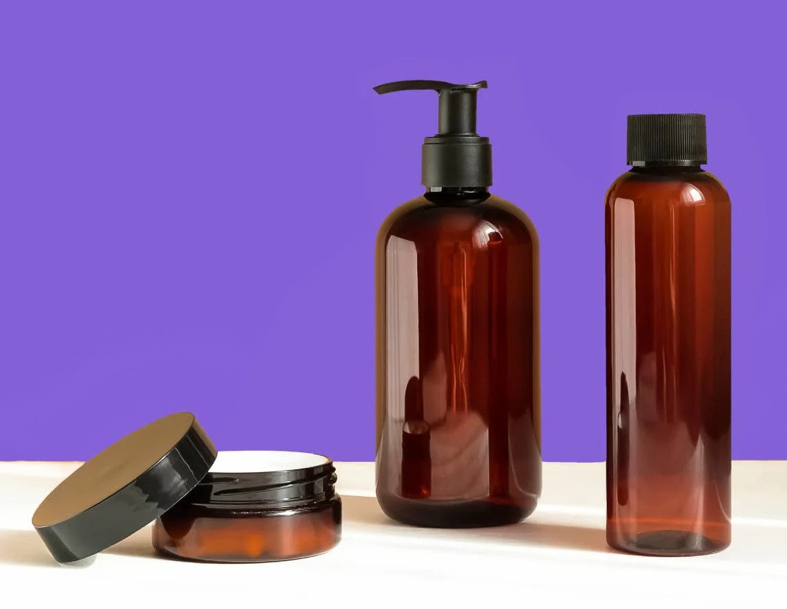 Amber glass bottles with pump dispensers and jar